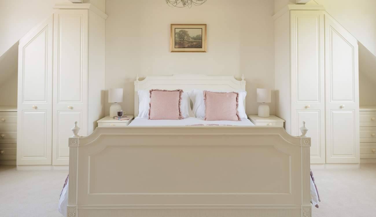 A sumptuous bedroom with twin wardrobes.