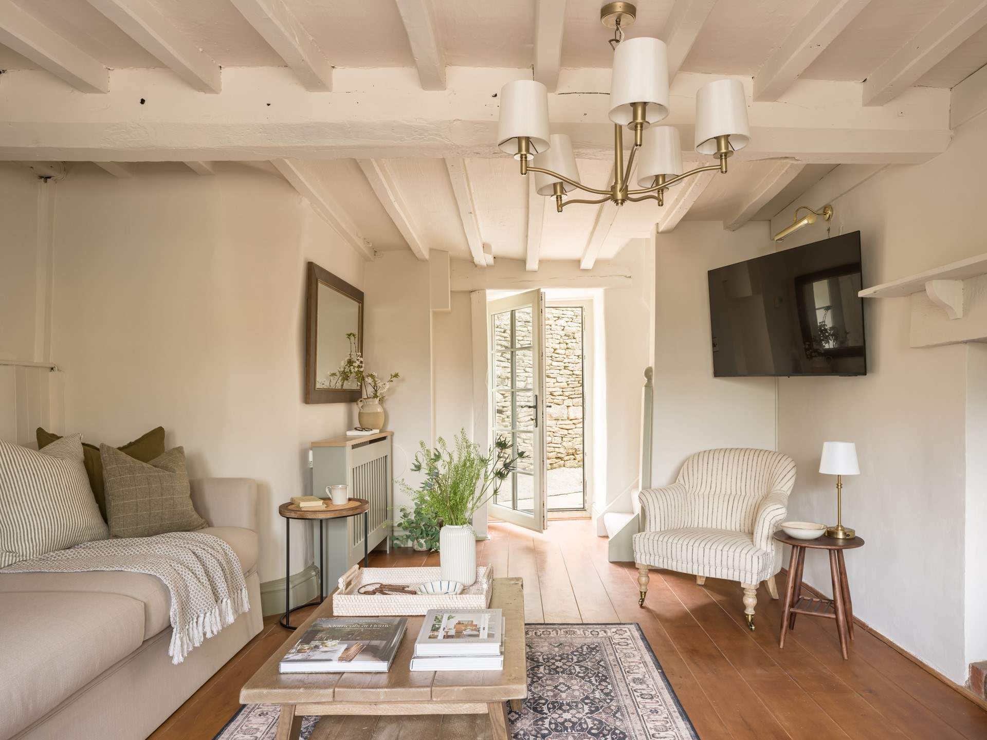 The door opens out onto the small courtyard with summer-house.