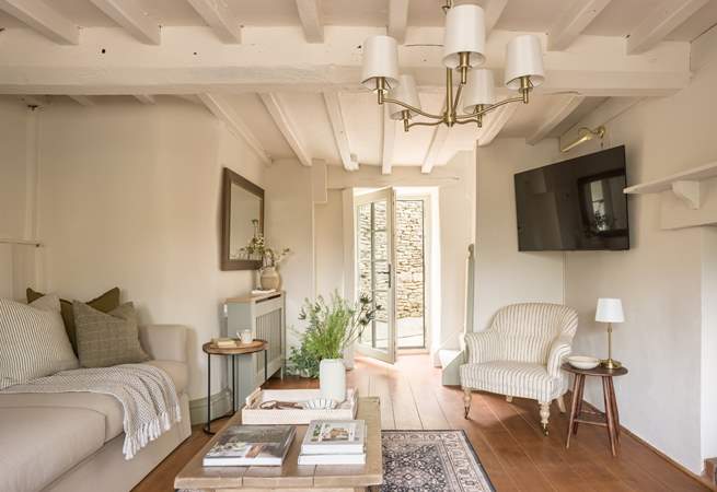 The door opens out onto the small courtyard with summer-house.
