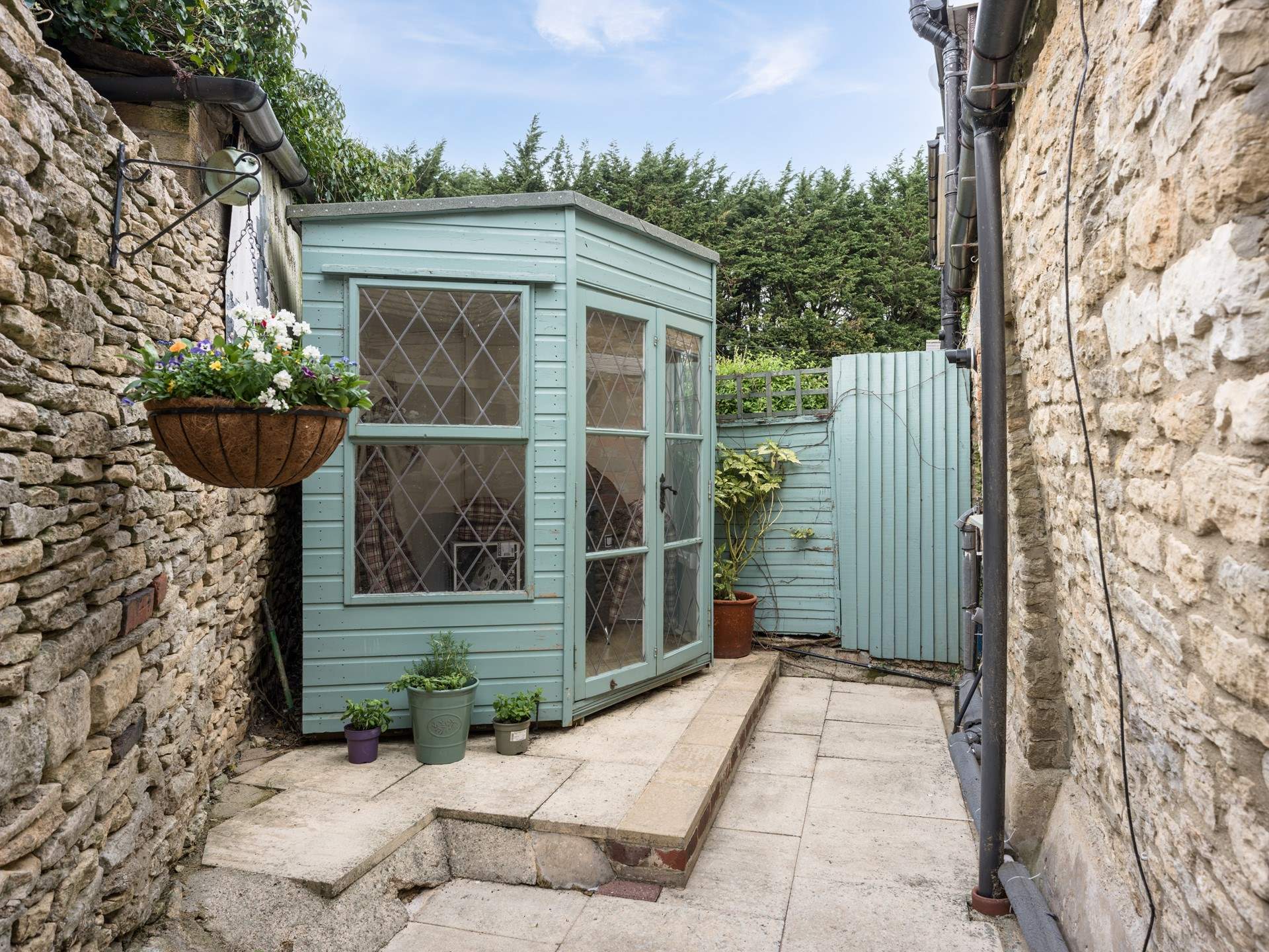 Th rear courtyard is very private with a summer-house and room to sit out in the sunshine.