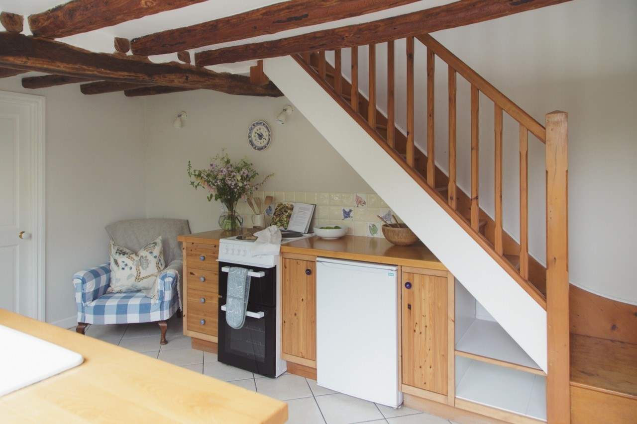 Step directly into the kitchen and dining-area, with the compact shower-room to the left.