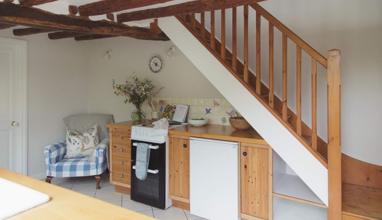 Step directly into the kitchen and dining-area, with the compact shower-room to the left.