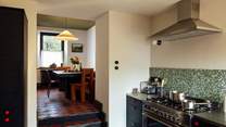 The open plan kitchen and dining-room are perfect for get togethers. 