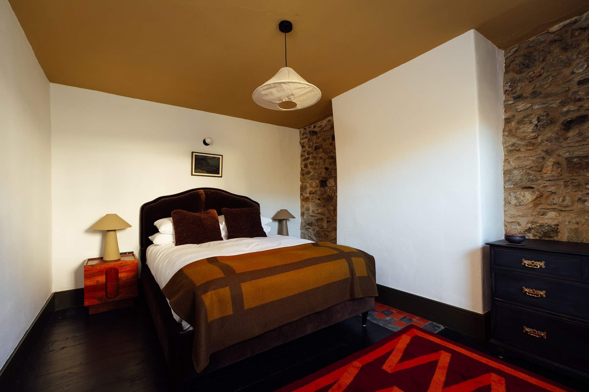 Hushed bedroom 1 with warm relaxing hues. 