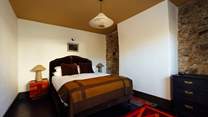 Hushed bedroom 1 with warm relaxing hues. 