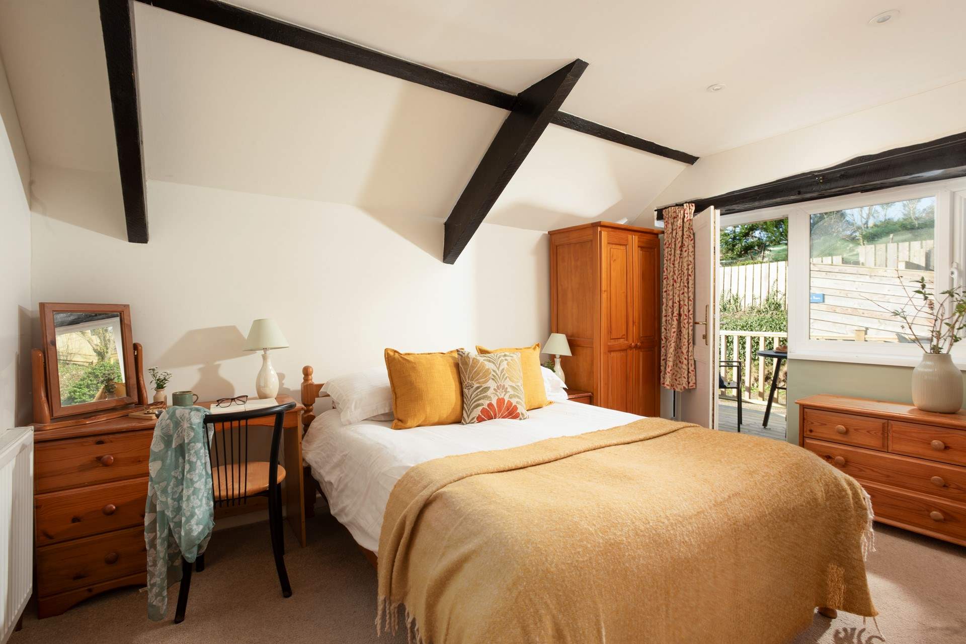 A door leads out to the decking area.