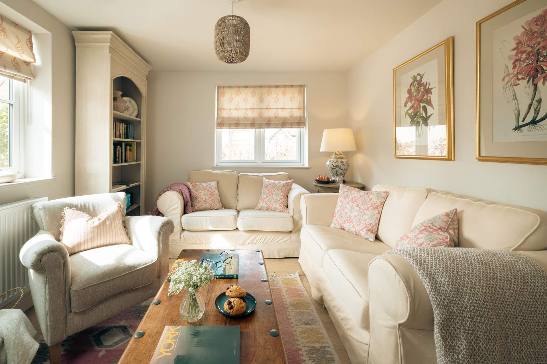 Pretty muted colours and Suzie Watson fabrics grace the sitting-room.