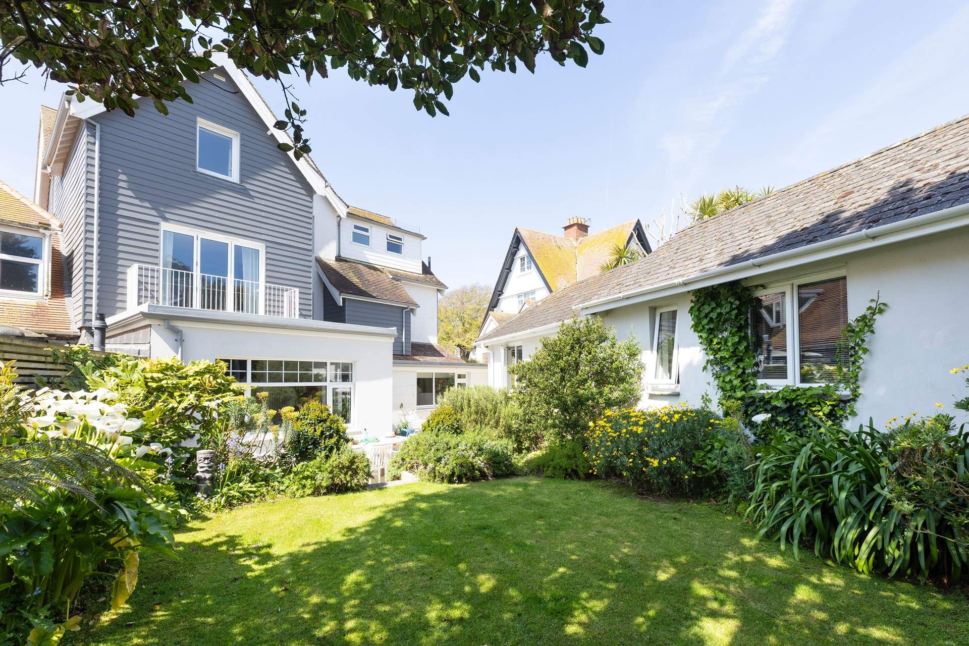 The pretty lawned garden at the back of the house catches the morning sun. 