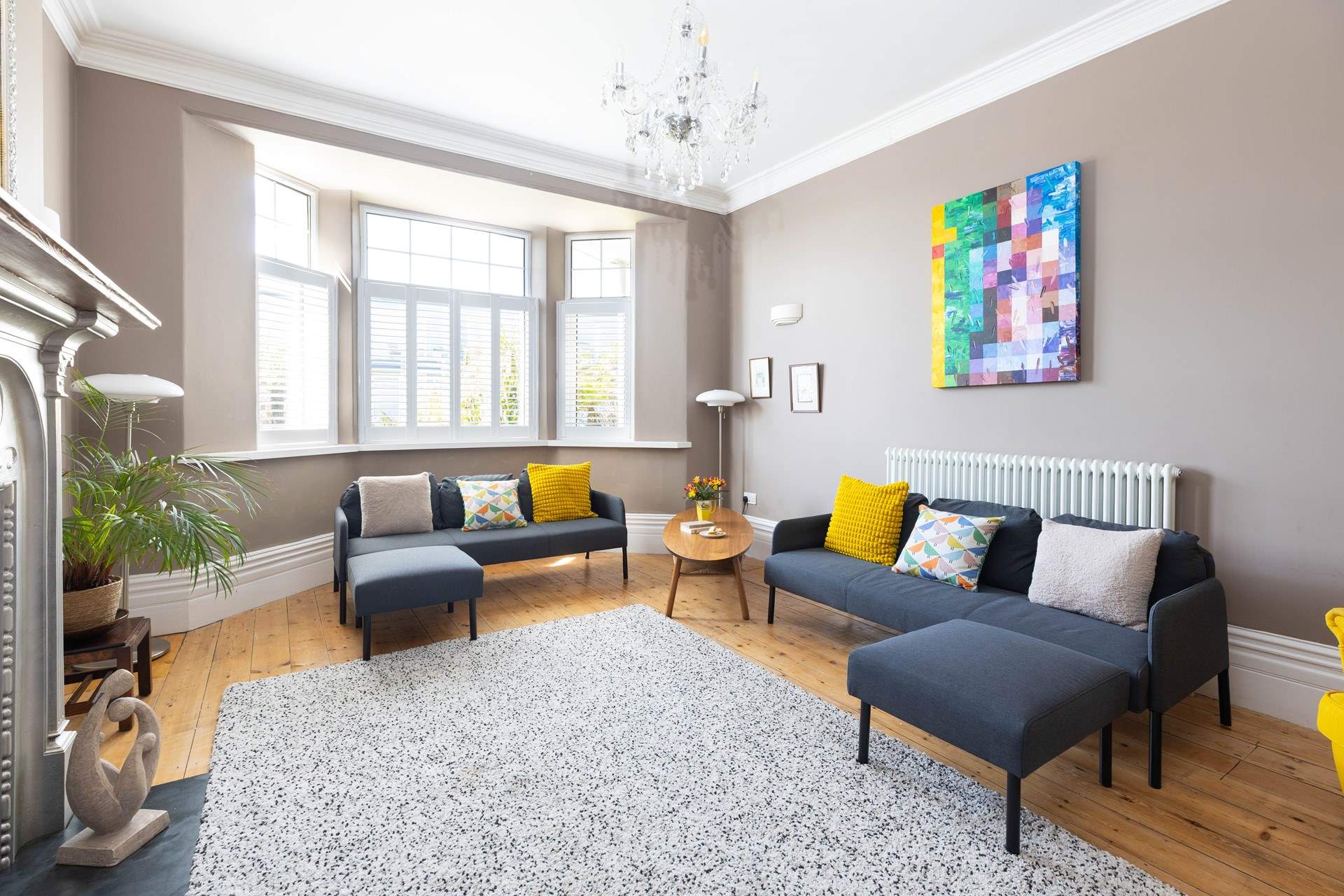 The light floods in through the large bay window. 