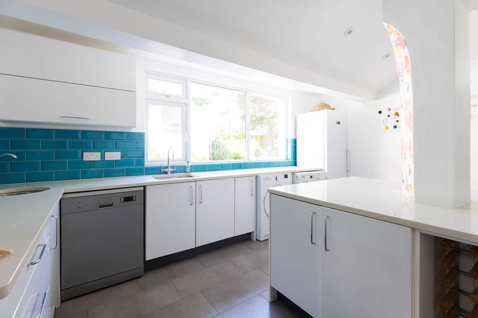 The handy utility-room has a second dishwasher and a large fridge. 