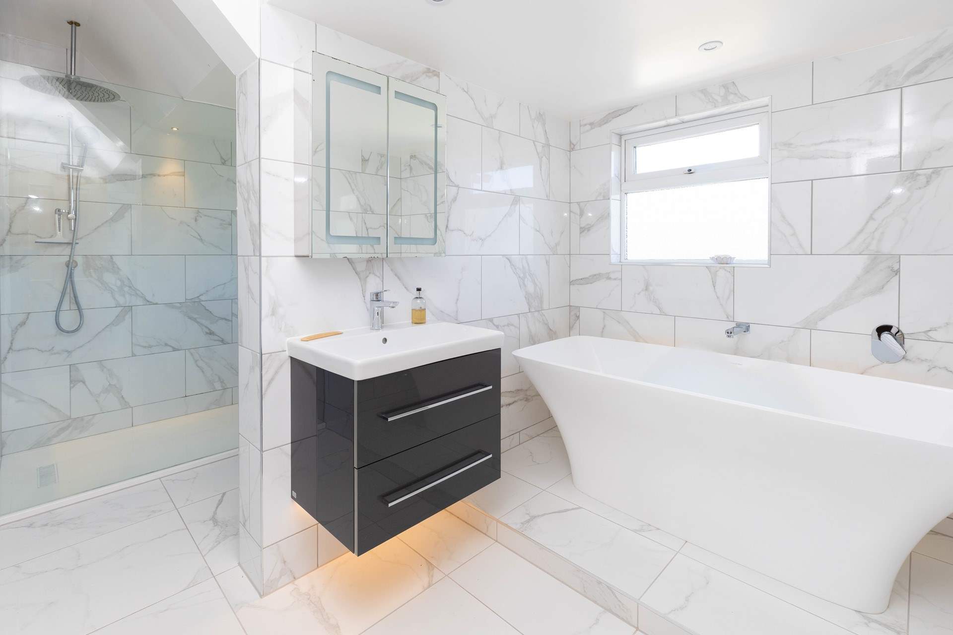 The principle bedroom has a beautiful en suite with a large shower and free-standing bath for long luxurious soaks. 
