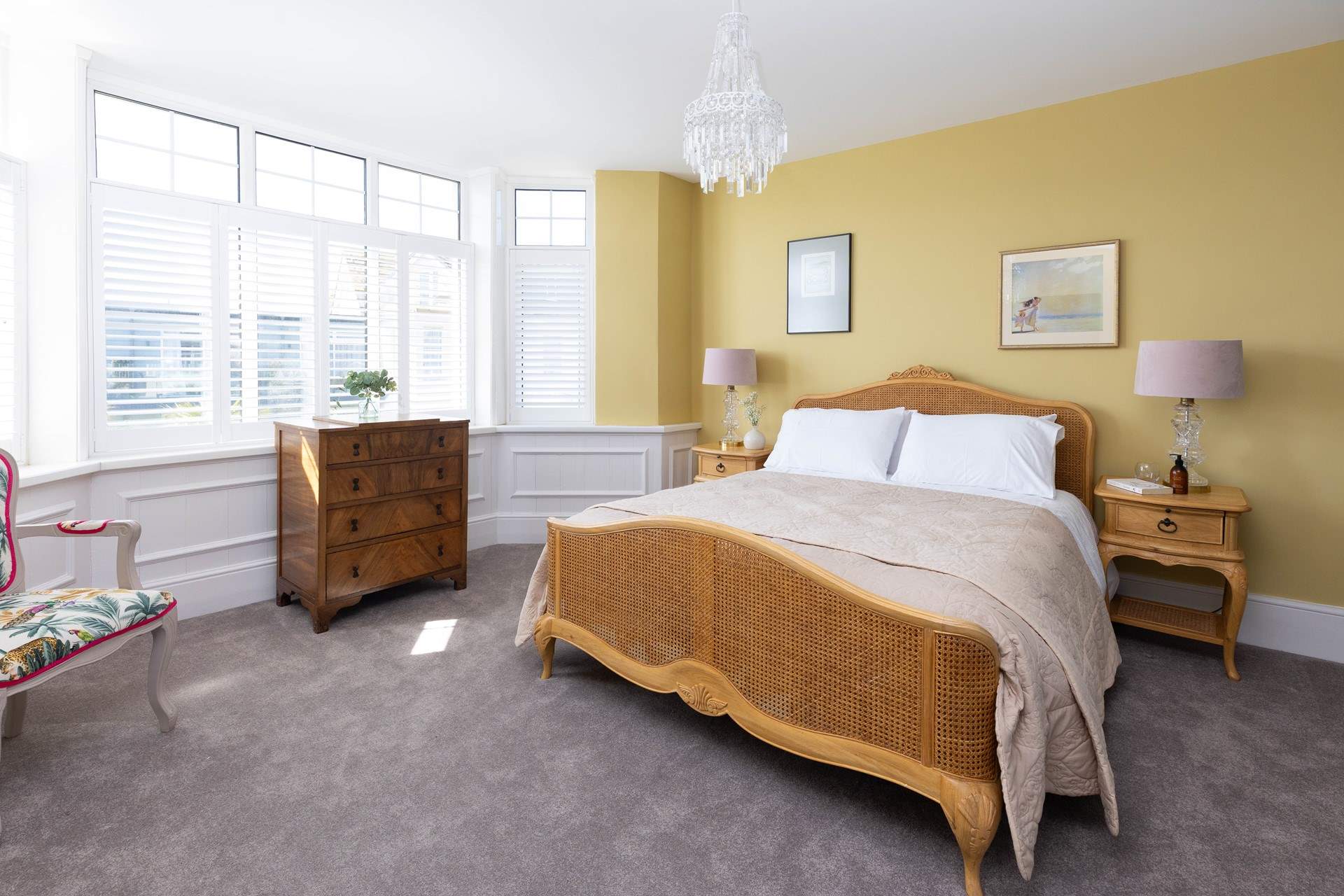 This bedroom has a king-size bed and styled in warm calming hues (Bedroom 1).