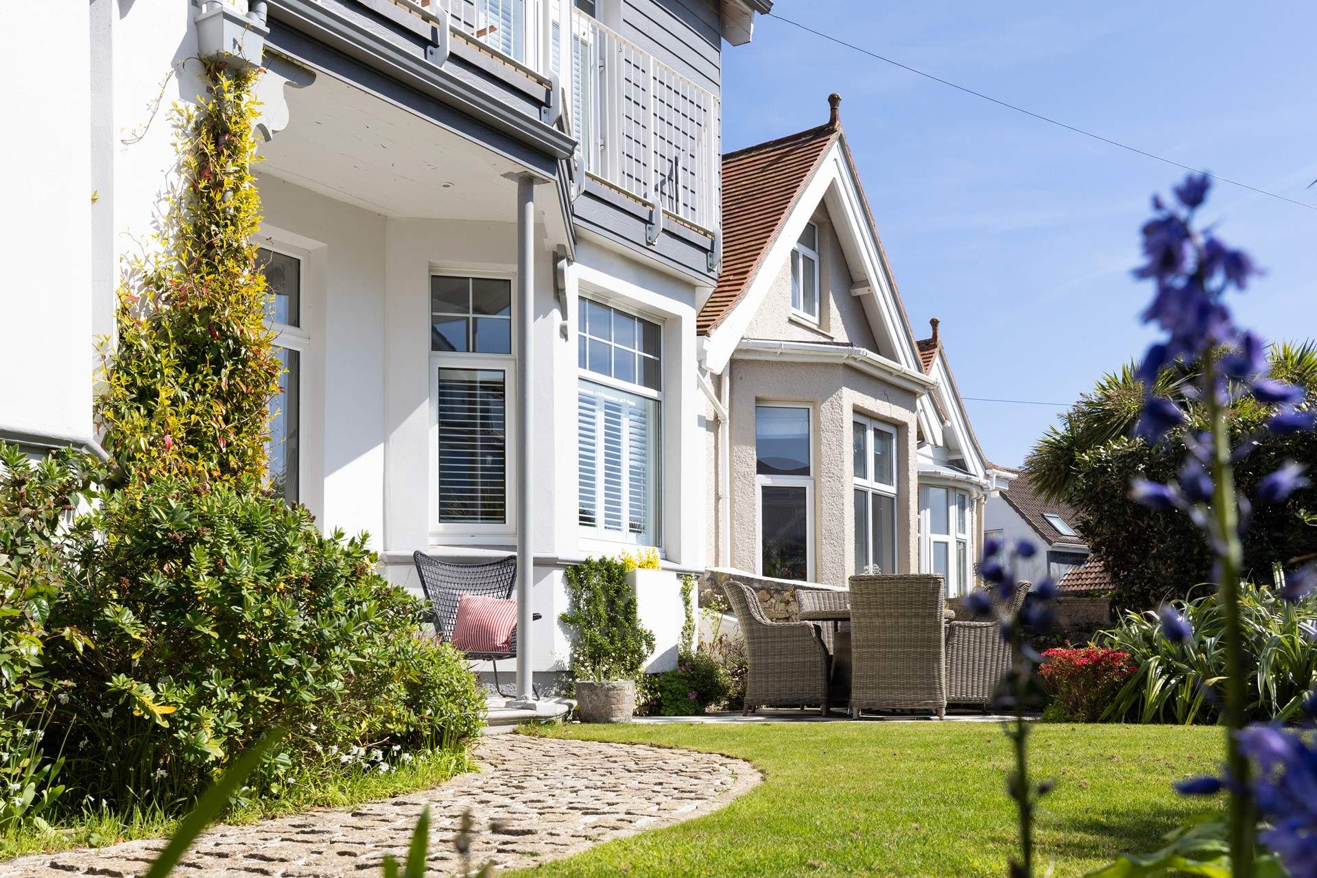 Through the front gate you are met by the pretty front garden and into your holiday abode.