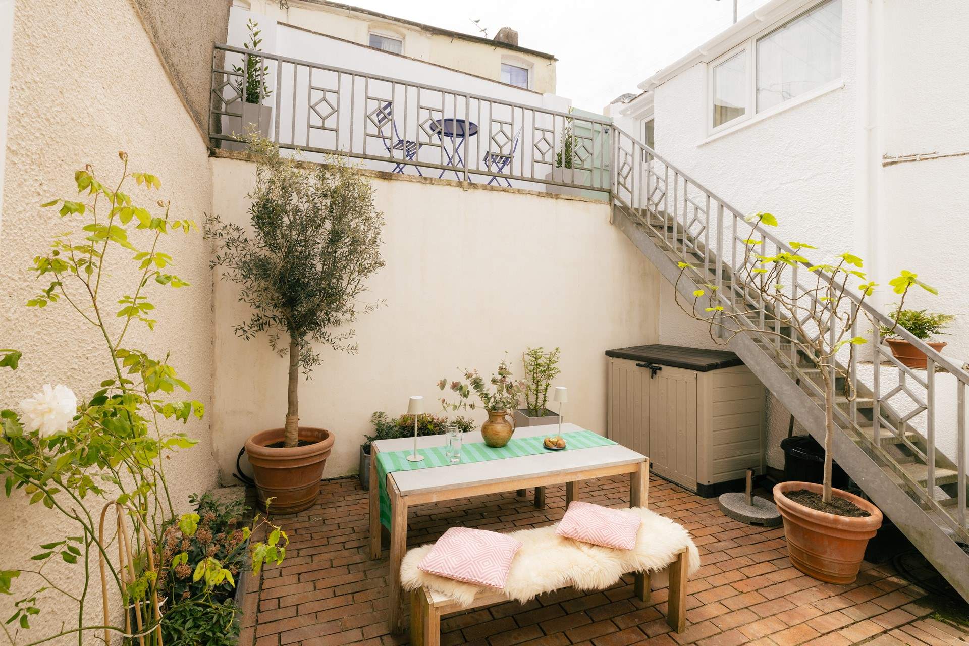 A private oasis to catch the evening sun. There's also an upper terrace with a bistro table and chairs.