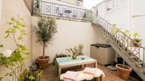 A private oasis to catch the evening sun. There's also an upper terrace with a bistro table and chairs.