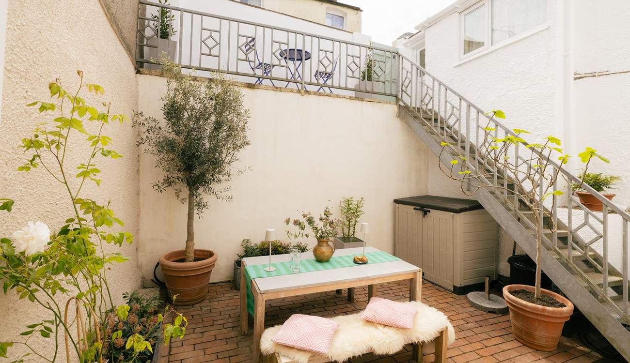 A private oasis to catch the evening sun. There's also an upper terrace with a bistro table and chairs.