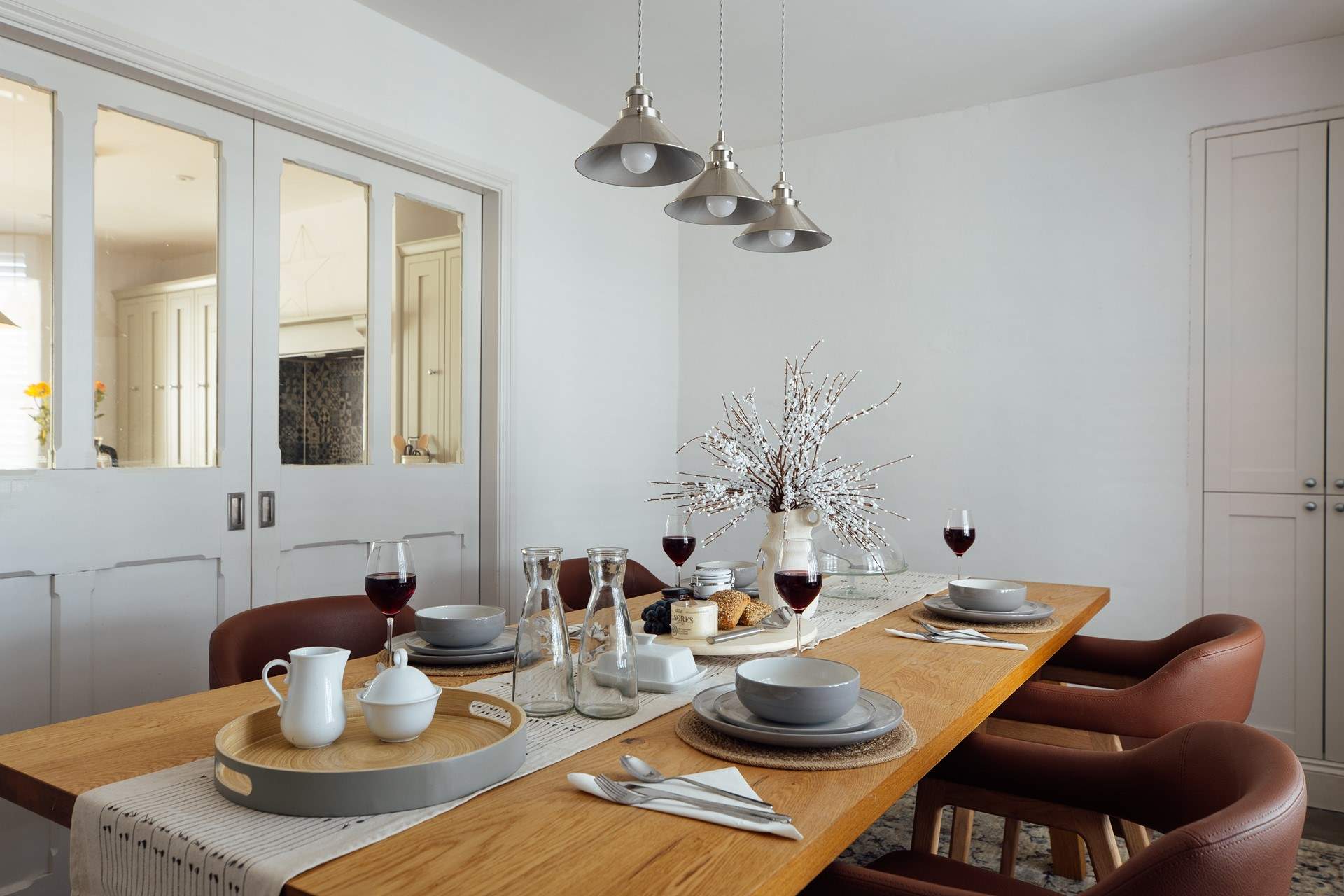 The quiet, understated elegance in the dining-room, enhanced by ambient lighting, soft tones and comfortable chairs. Perfect place to linger with friends and family. 