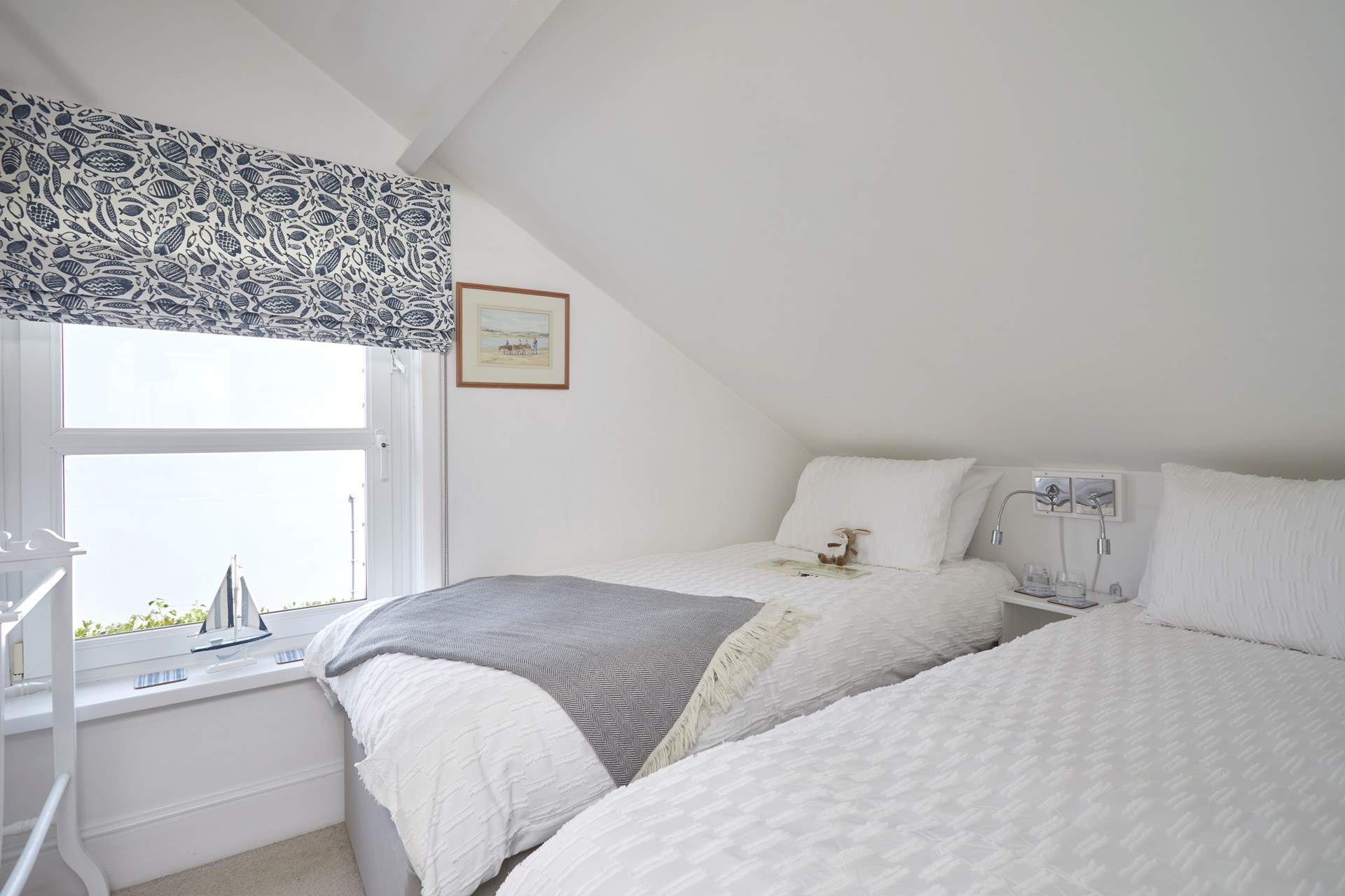 The twin bedroom is fresh and bright - please mind your head on the sloping ceilings.