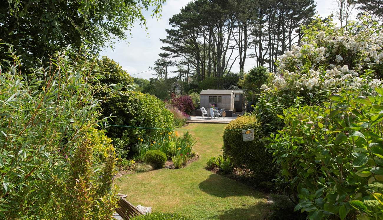 A beautifully maintained garden, fully enclosed so safe for your children and four legged friends. There is a gate separating the garden from the parking area.