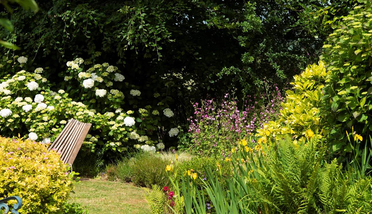 Well stocked borders create an enchanting space.