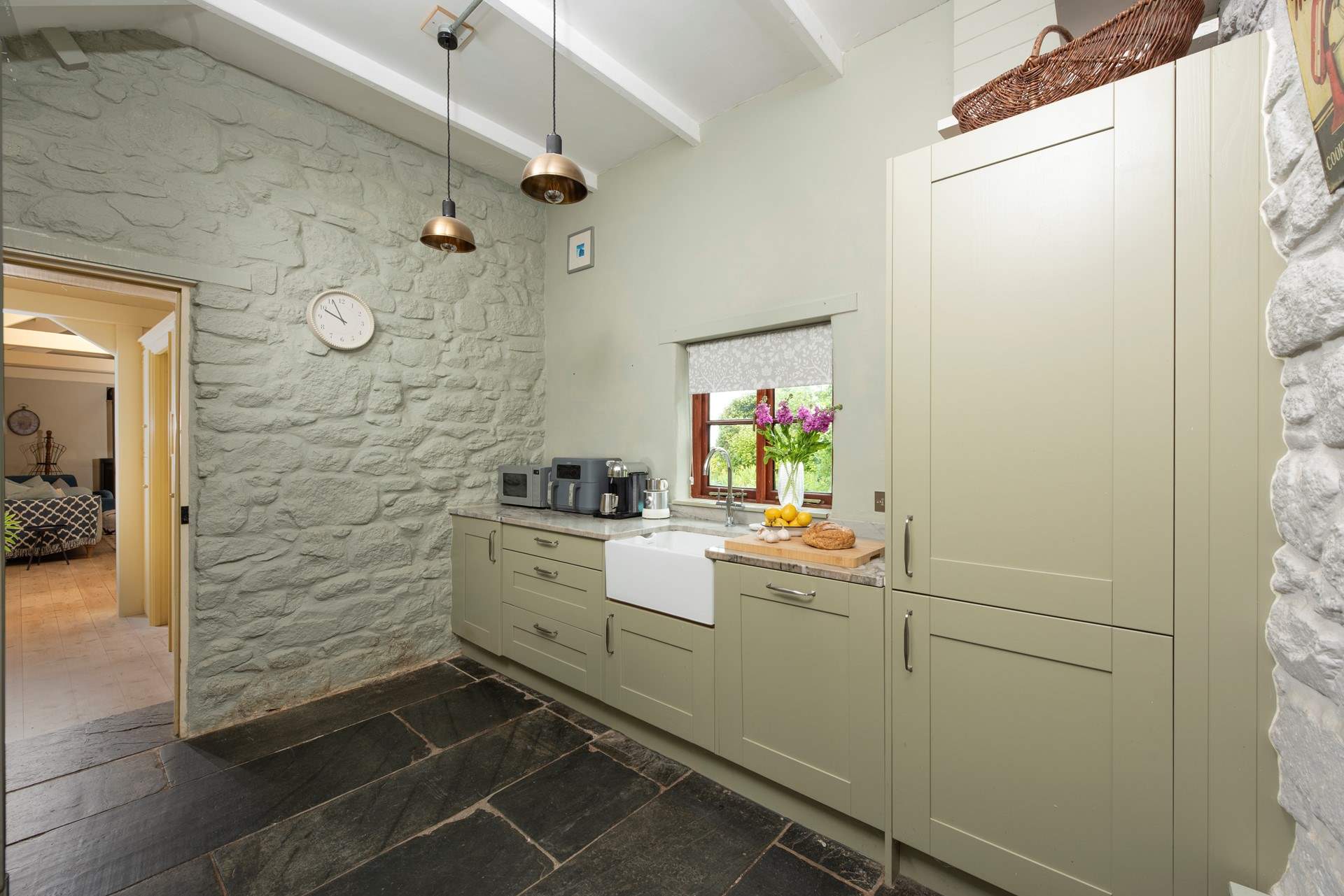 The kitchen leading through to the first of two sitting-rooms.