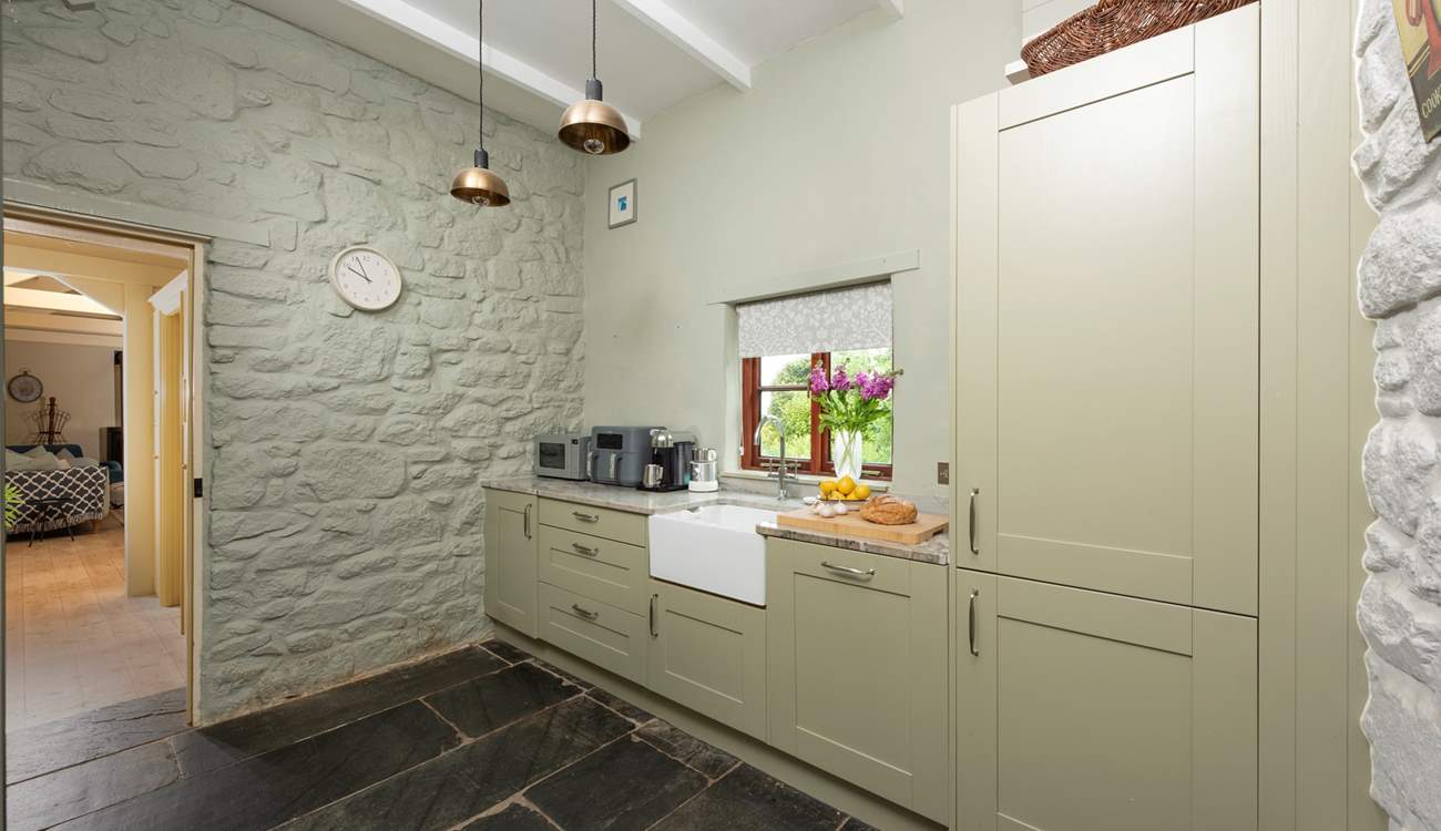 The kitchen leading through to the first of two sitting-rooms.