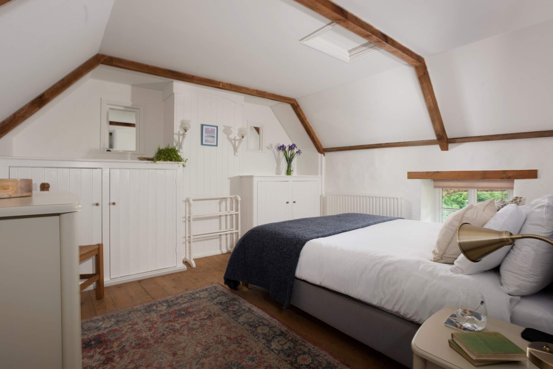 Bedroom 1 has a restful king-size bed and characterful wooden floors.