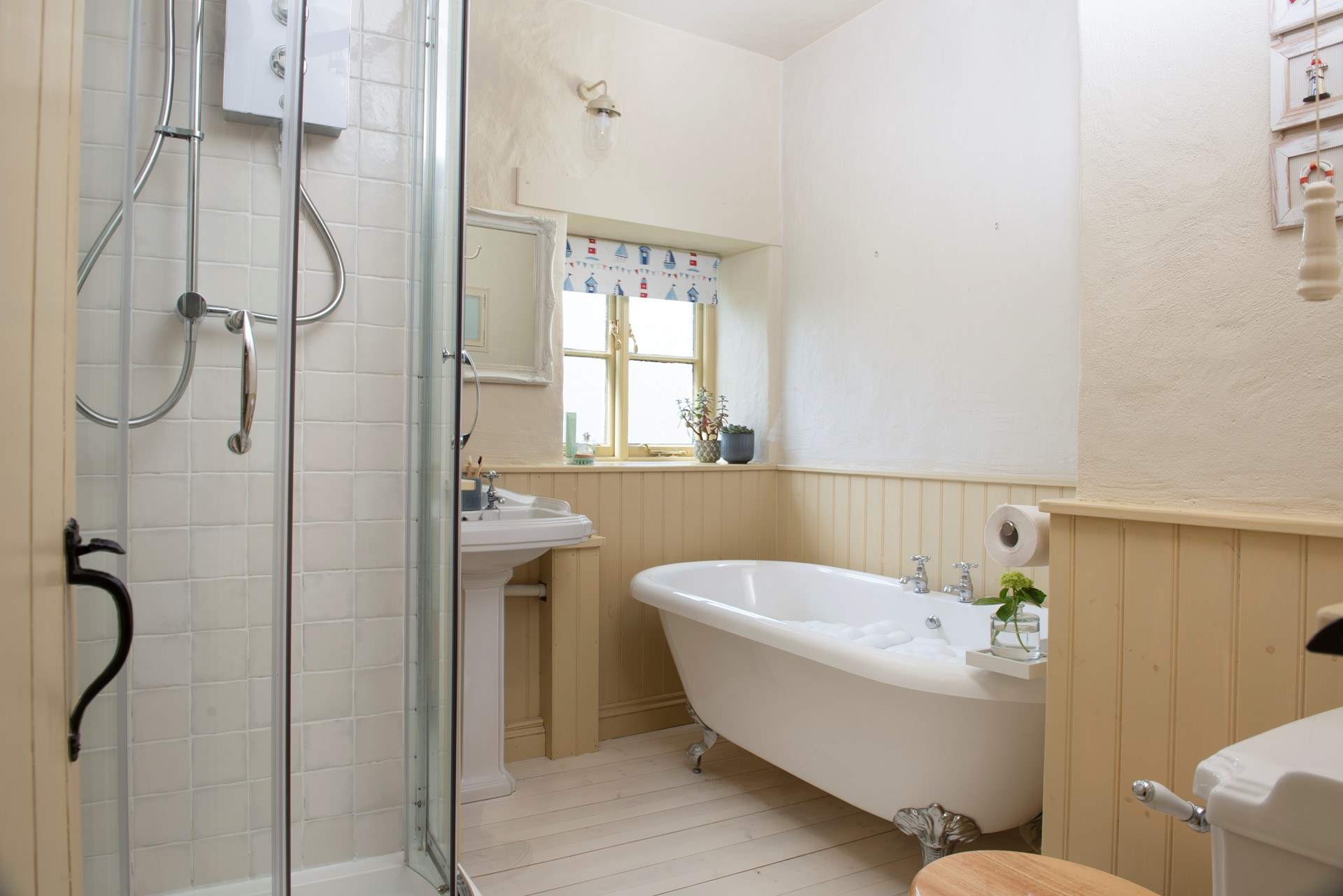 The family bathroom has a roll top bath and separate electric shower.