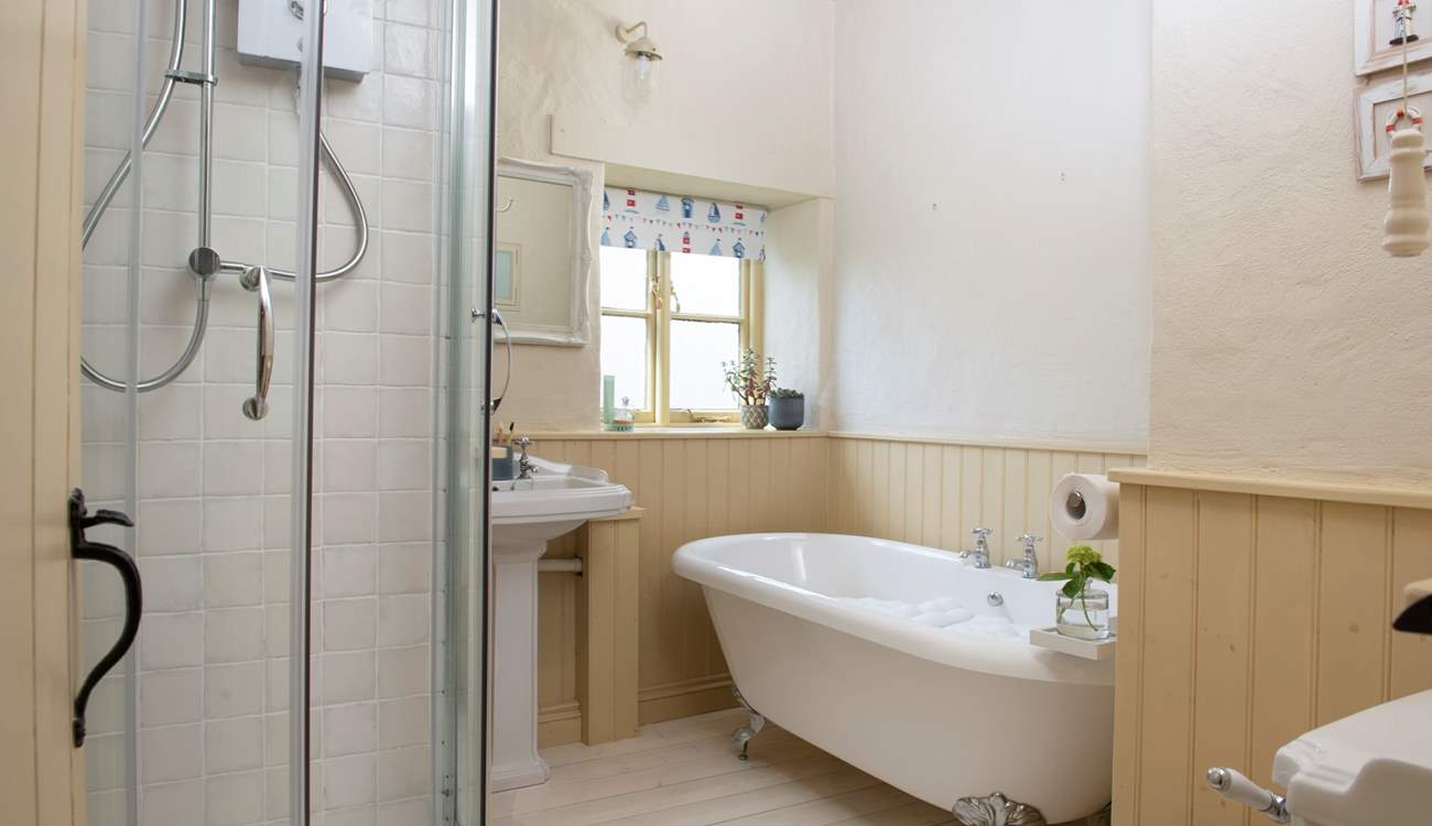 The family bathroom has a roll-top bath and separate electric shower.