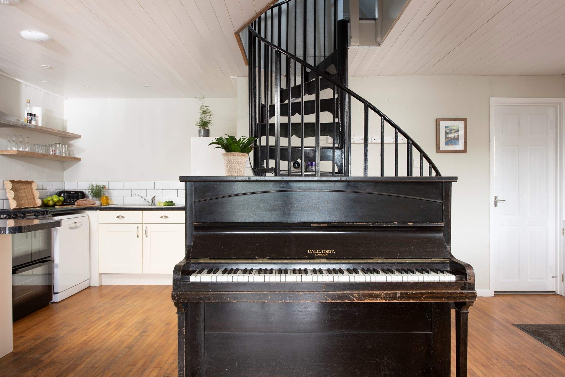 The spiral stairs lead up to the first floor bedrooms and what could be better than a good old sing song around the piano.