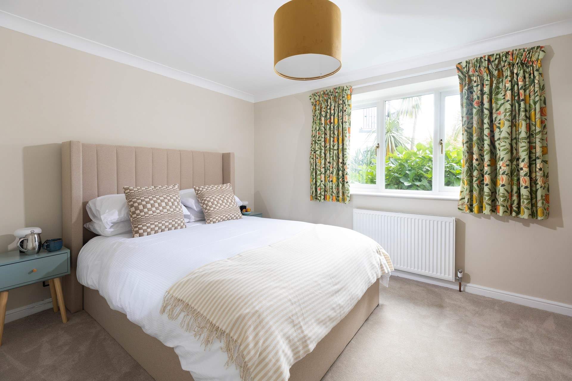 Beautiful William Morris fabrics add splashes of colour to this tranquil room. 