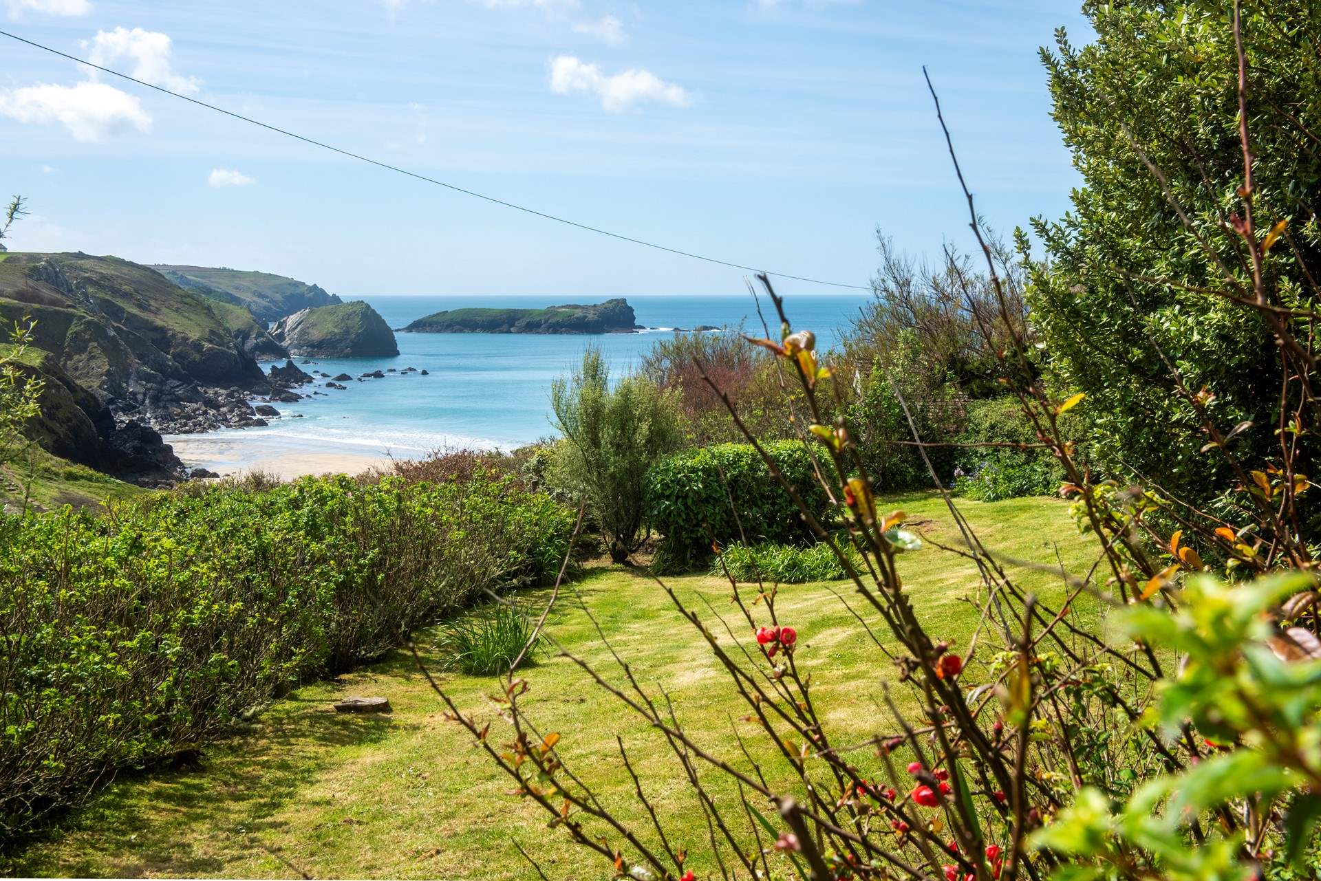 The view of the beach from the lower garden sitting-area.