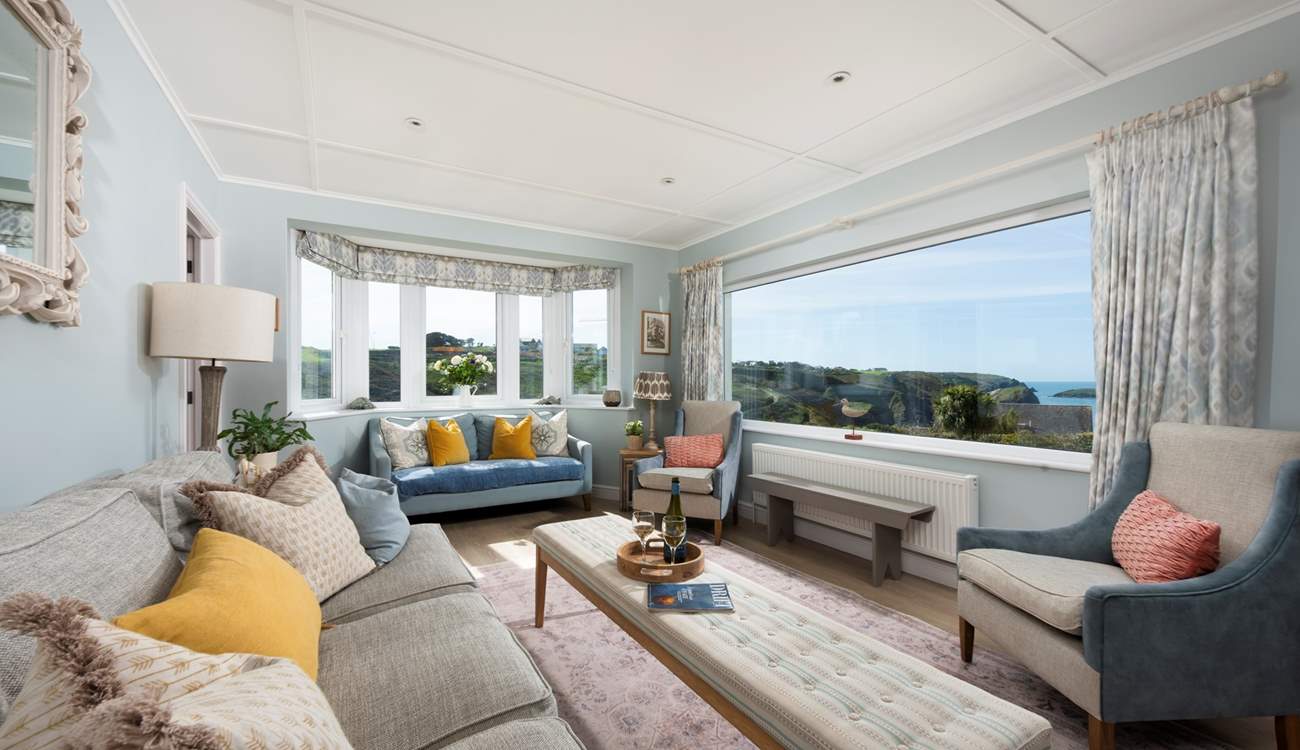 The sitting-room boasts enormous windows to frame the gorgeous backdrop.