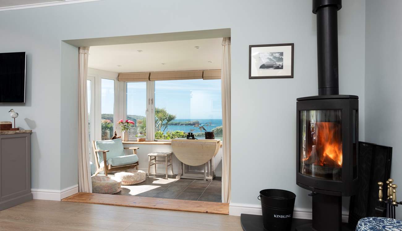 The sitting-room has  a wood-burner and opens up into the sun-room. 