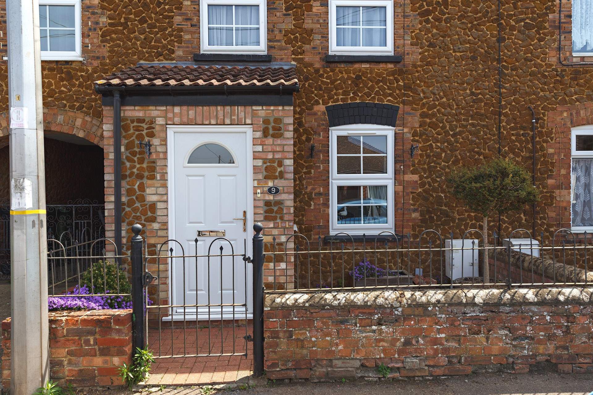 Bee's Cottage sits in a row of similar pretty cottages. 