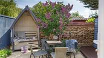 The rear patio is a charming, sheltered spot. 