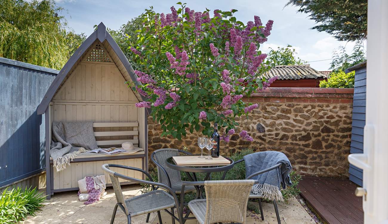 The rear patio is a charming, sheltered spot. 