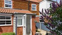 The rear door opens out from the utility room onto the sunny patio. 
