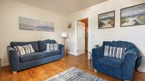 Artwork of local seascapes adorns the walls.  (Please note that there are now two sofa's in this room).