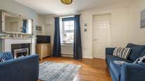 The sitting-room is beautifully furnished with a seaside theme. 