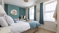 Beautiful linens await in the double bedroom. 