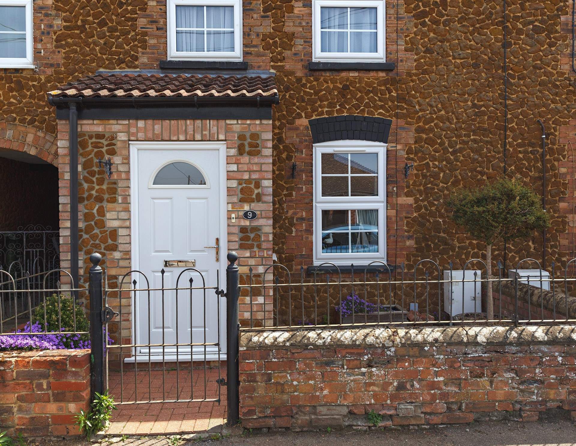 Bee's Cottage sits in a row of similar pretty cottages. 