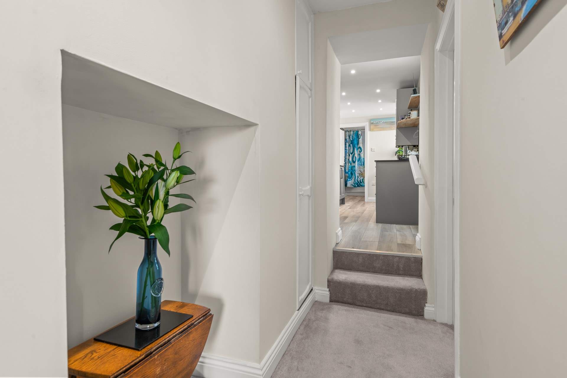 The hallway links the apartment perfectly, with two steps up into the kitchen area and bathroom beyond.