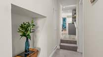 The hallway links the apartment perfectly, with two steps up into the kitchen area and bathroom beyond.