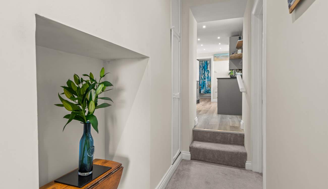 The hallway links the apartment perfectly, with two steps up into the kitchen area and bathroom beyond.