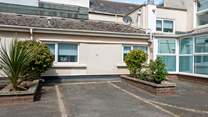 The Sandy Den does offer a parking space, suitable for small to medium sized cars due to the turning space available.