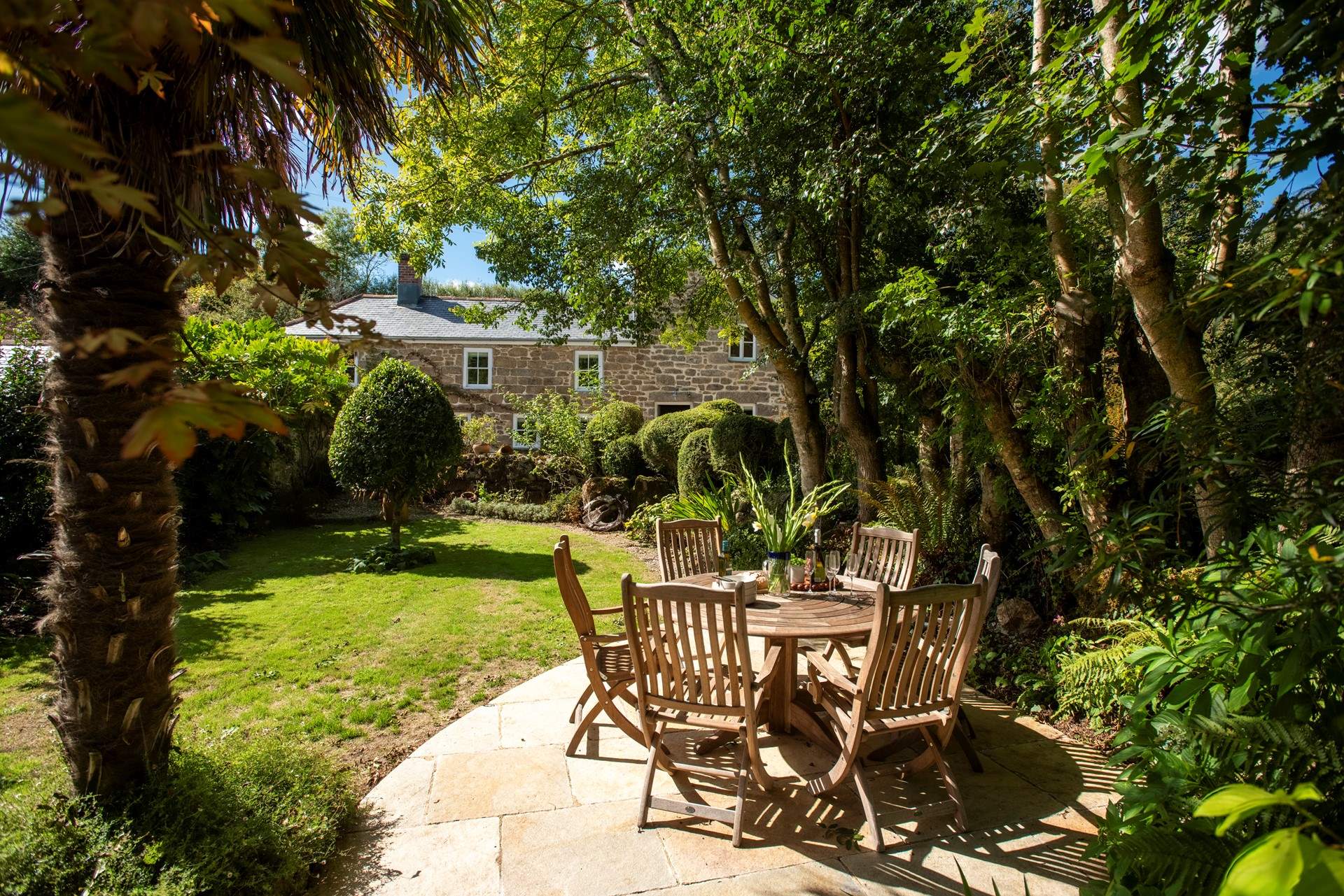 Dine al fresco beneath the leafy canopy of mature trees.