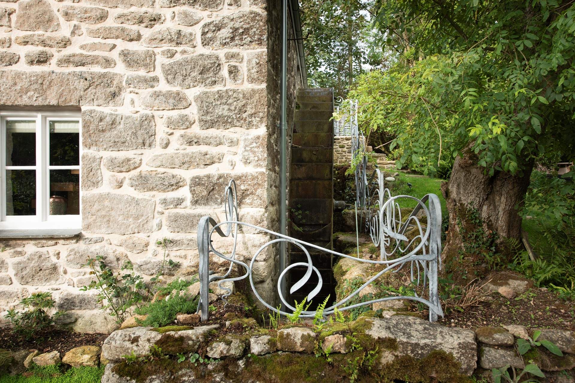 Bespoke railings protect the original water wheel.