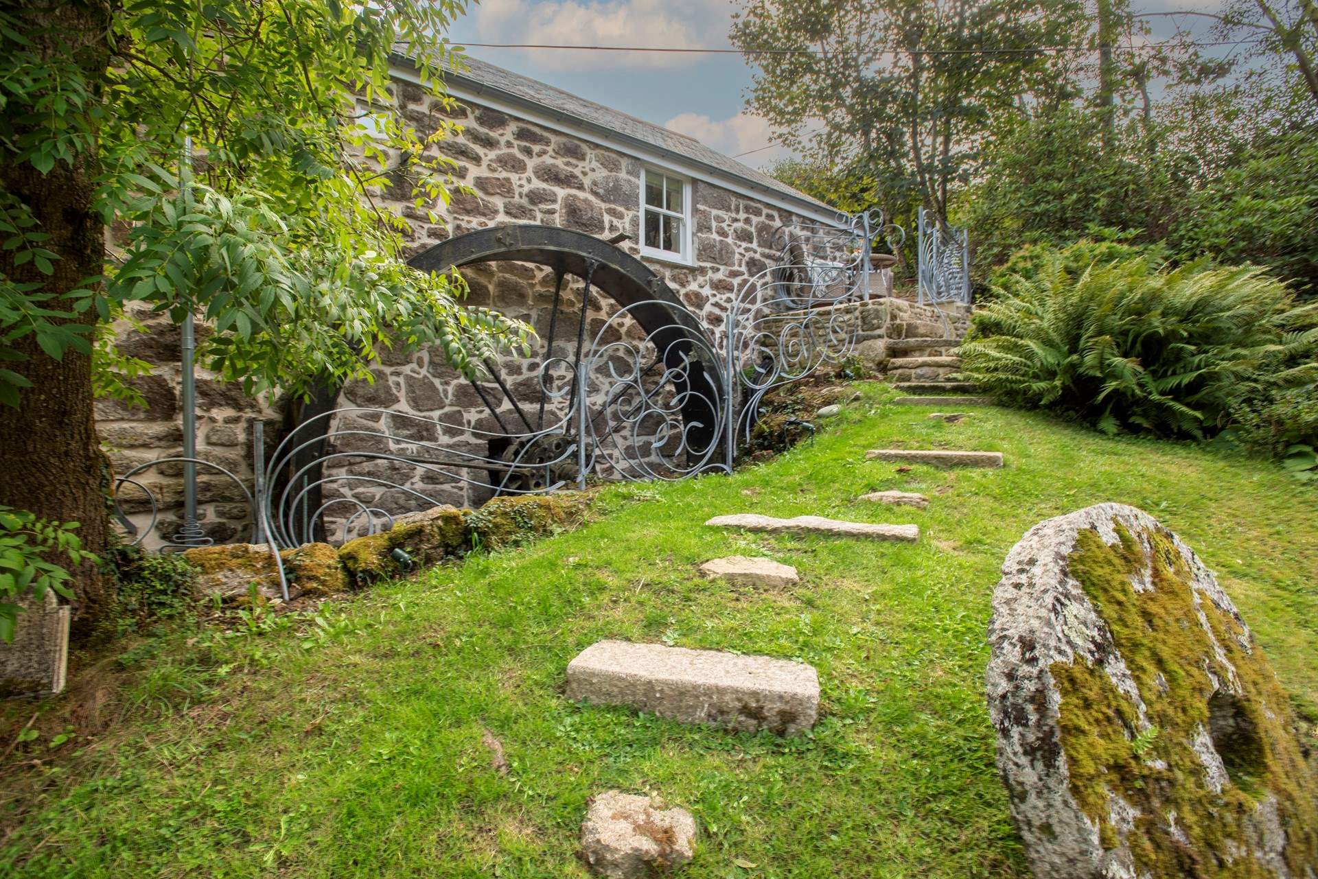 The huge original water wheel remains as a reminder of the mill's working past.