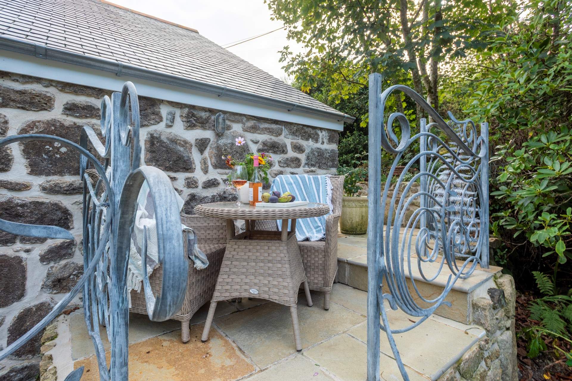 Enjoy a glass of wine on the terrace overlooking the gardens. This terrace is accessed by steps from the garden or the door from the upstairs sitting-room.